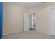 Neutral carpeted bedroom with doors to ensuite bathroom and closet at 8382 Christopher Ln, Weeki Wachee, FL 34613