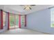 Blue bedroom with vaulted ceiling, ceiling fan, and pool view at 8382 Christopher Ln, Weeki Wachee, FL 34613