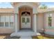Close-up of the grand entrance featuring double doors and decorative columns at 8382 Christopher Ln, Weeki Wachee, FL 34613