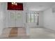 Inviting foyer with tiled steps, a window with blinds, and a view into the living area at 8382 Christopher Ln, Weeki Wachee, FL 34613