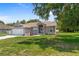 Charming single-story home with an attached two-car garage and well-manicured lawn at 8382 Christopher Ln, Weeki Wachee, FL 34613