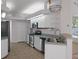 Bright kitchen featuring white cabinetry, stainless steel appliances, and a double sink at 8382 Christopher Ln, Weeki Wachee, FL 34613