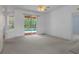 Open living space with a ceiling fan and access to the screened-in pool area at 8382 Christopher Ln, Weeki Wachee, FL 34613