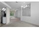 Open-concept living space featuring kitchen, dining, and access to the screened-in pool at 8382 Christopher Ln, Weeki Wachee, FL 34613