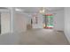 Bright living room with neutral carpet and sliding glass doors leading to the pool area at 8382 Christopher Ln, Weeki Wachee, FL 34613