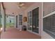 Covered patio area with a ceiling fan, columns, and view of the screened-in pool at 8382 Christopher Ln, Weeki Wachee, FL 34613