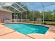 Enjoy the screened-in pool with blue tiling and spacious deck, perfect for relaxing and entertaining at 8382 Christopher Ln, Weeki Wachee, FL 34613