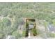 Aerial view of a property with a pool, mature trees, and an outlined property boundary at 8402 Lake Hill Ct, Spring Hill, FL 34608
