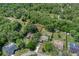 An aerial shot displays this property's location surrounded by lush trees and nature, offering serene living at 8402 Lake Hill Ct, Spring Hill, FL 34608