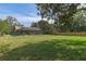 Expansive backyard view, perfect for recreation or relaxation, and the screen enclosed lanai at 8402 Lake Hill Ct, Spring Hill, FL 34608
