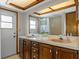 Bathroom highlighting double vanity, a large mirror, and a combination tub/shower at 8402 Lake Hill Ct, Spring Hill, FL 34608