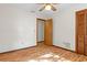 Bedroom showcasing light hardwood floors, ceiling fan, closet and neutral paint at 8402 Lake Hill Ct, Spring Hill, FL 34608