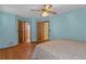 Airy bedroom with multiple door entryways, wood look floors, and natural light at 8402 Lake Hill Ct, Spring Hill, FL 34608
