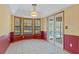 Bright breakfast nook with bay window, French doors, and a view of the pool at 8402 Lake Hill Ct, Spring Hill, FL 34608