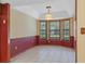 Cozy breakfast nook with large bay window offering natural light and serene views at 8402 Lake Hill Ct, Spring Hill, FL 34608