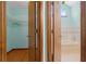 Dual-door view of walk-in closet and tiled bathroom with soaking tub and natural light at 8402 Lake Hill Ct, Spring Hill, FL 34608