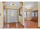 Elegant foyer featuring a decorative glass front door and adjacent dining area at 8402 Lake Hill Ct, Spring Hill, FL 34608