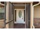 Close-up of the front door, showcasing decorative glass and secure entry features, framed by a screen enclosure at 8402 Lake Hill Ct, Spring Hill, FL 34608