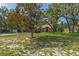 Beautiful single-story home featuring a lush front lawn, mature trees, and well-maintained landscaping at 8402 Lake Hill Ct, Spring Hill, FL 34608