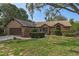Charming single-story home with a well-manicured lawn and mature landscaping providing great curb appeal at 8402 Lake Hill Ct, Spring Hill, FL 34608
