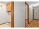 Hallway featuring hardwood floors, wood trim and doors leading to additional rooms at 8402 Lake Hill Ct, Spring Hill, FL 34608