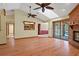Spacious living room showcasing a brick fireplace, vaulted ceilings, and access to the kitchen at 8402 Lake Hill Ct, Spring Hill, FL 34608