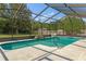 Inviting screened-in pool with a waterfall feature and meticulously maintained landscaping at 8402 Lake Hill Ct, Spring Hill, FL 34608