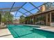 Refreshing screened-in pool and patio with a seamless indoor-outdoor transition at 8402 Lake Hill Ct, Spring Hill, FL 34608