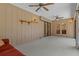 Spacious sunroom featuring carpet, ceiling fans, and paneled walls at 8402 Lake Hill Ct, Spring Hill, FL 34608