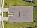 Aerial view of house roof highlighting the architectural design, complemented by a driveway and landscaped yard at 8431 Ocean Tides Cv, Parrish, FL 34219