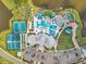 Aerial view of community amenities, including a pool, clubhouse, tennis courts, and parking area near a pond at 8431 Ocean Tides Cv, Parrish, FL 34219
