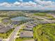 Expansive aerial view of a Primary-planned community featuring modern homes, lakes, and landscaped common areas at 8431 Ocean Tides Cv, Parrish, FL 34219