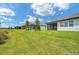 Picture of a spacious backyard with well-maintained lawn and screened lanais at 8431 Ocean Tides Cv, Parrish, FL 34219