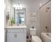 Bright bathroom featuring granite vanity top, modern lighting, and shower-tub combo at 8431 Ocean Tides Cv, Parrish, FL 34219
