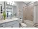Stylish bathroom featuring a granite vanity, shower-tub combo, and modern fixtures at 8431 Ocean Tides Cv, Parrish, FL 34219