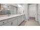 Modern bathroom with dual sinks, a granite countertop, and a glass-enclosed shower at 8431 Ocean Tides Cv, Parrish, FL 34219
