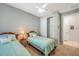 Bright bedroom with two beds, ceiling fan, and a closet at 8431 Ocean Tides Cv, Parrish, FL 34219