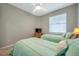 Comfortable bedroom featuring two twin beds, ceiling fan and natural lighting at 8431 Ocean Tides Cv, Parrish, FL 34219