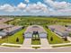 Beautiful paired villas with modern exteriors, brick driveways, and lush landscaping in a vibrant community at 8431 Ocean Tides Cv, Parrish, FL 34219