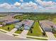 Aerial view of modern paired villas featuring brick driveways and well-maintained lawns in a Primary-planned community at 8431 Ocean Tides Cv, Parrish, FL 34219