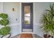 Charming front door with decorative glass, stylish hardware, and a 'Welcome Home' doormat, surrounded by manicured plants at 8431 Ocean Tides Cv, Parrish, FL 34219