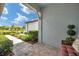 Inviting front porch with brick flooring and views of the landscaped front yard at 8431 Ocean Tides Cv, Parrish, FL 34219