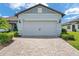 Charming garage with brick paver driveway and professionally landscaped yard at 8431 Ocean Tides Cv, Parrish, FL 34219