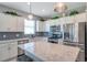 Charming kitchen boasts white cabinets, stainless steel appliances, and a large island at 8431 Ocean Tides Cv, Parrish, FL 34219