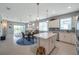 Open-concept kitchen with granite countertops, white cabinetry, and modern stainless steel appliances at 8431 Ocean Tides Cv, Parrish, FL 34219