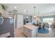 Open kitchen and dining area with stainless steel refrigerator and center island at 8431 Ocean Tides Cv, Parrish, FL 34219