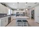 Bright kitchen featuring stainless steel appliances, a center island with seating, and white cabinetry with modern fixtures at 8431 Ocean Tides Cv, Parrish, FL 34219