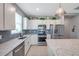 Charming kitchen features white cabinets, stainless steel appliances, and tile backsplash at 8431 Ocean Tides Cv, Parrish, FL 34219