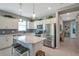 Lovely kitchen with stainless steel appliances, subway tile backsplash, a center island with seating, and plenty of cabinetry at 8431 Ocean Tides Cv, Parrish, FL 34219