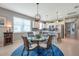 Open floor plan with dining area and kitchen featuring white cabinets and stainless steel appliances at 8431 Ocean Tides Cv, Parrish, FL 34219